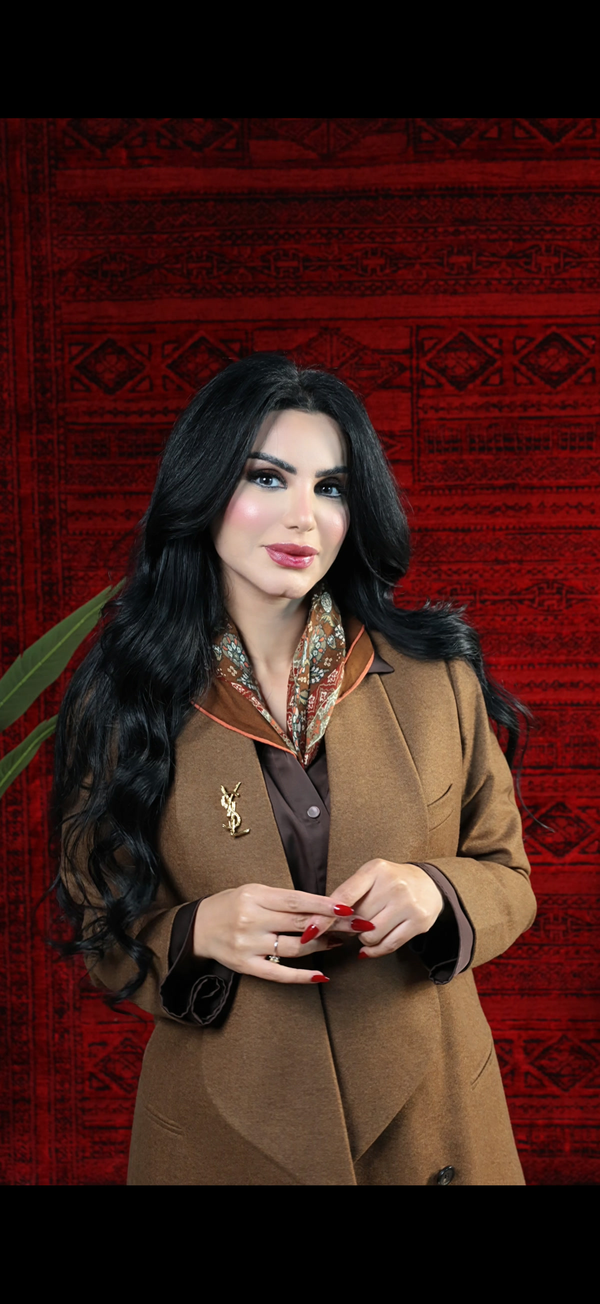 Layal — editorial portrait on red tapestry